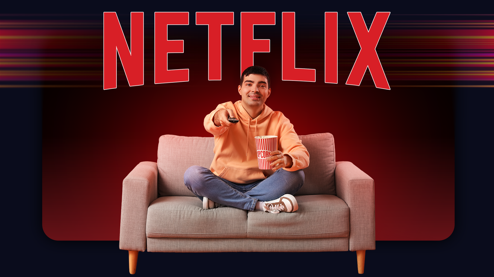 Man sitting on a couch holding popcorn and a remote control, smiling while watching TV, with a large red Netflix logo in the background.