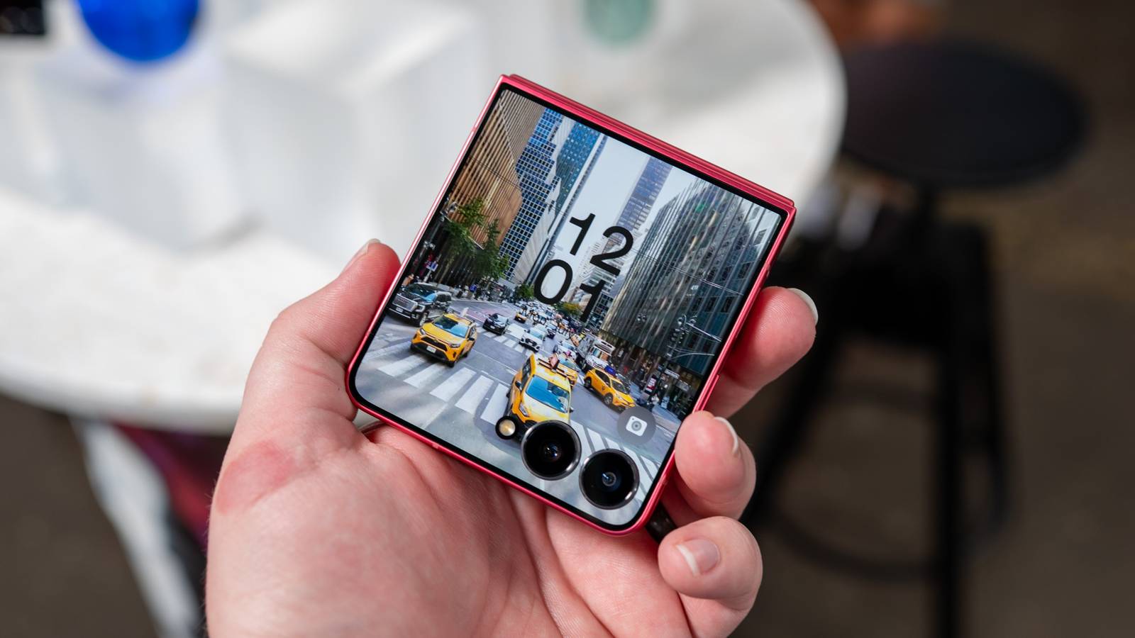 Person holding the Galaxy Z Flip 7 showing the cover display.