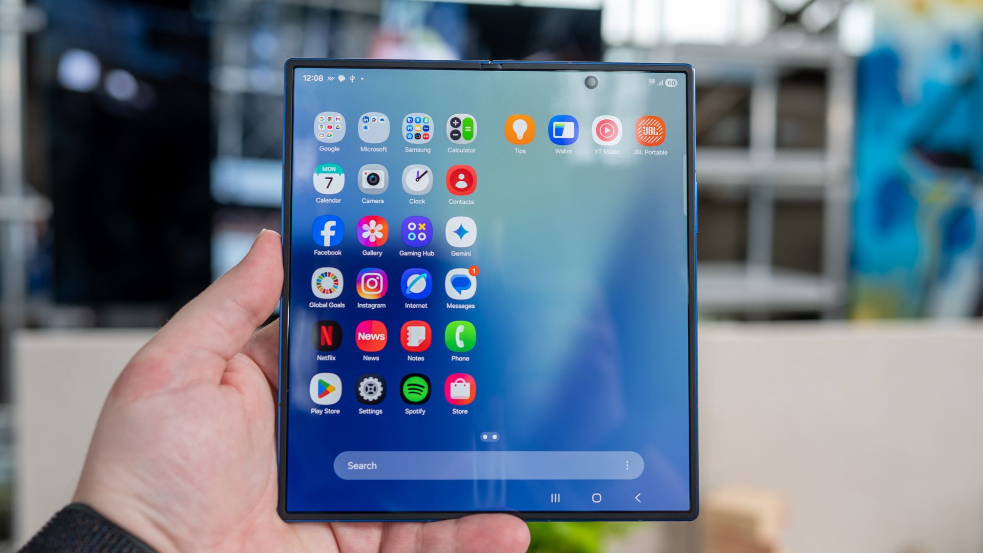 person holding the samsung galaxy z fold 7 unfolded showing the app drawer on the inside display 54642360950 o