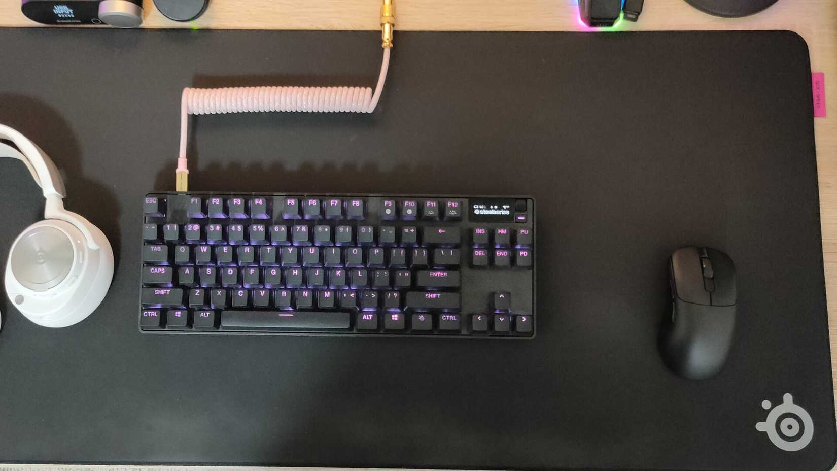 The SteelSeries QCK Performance Speed gaming mousepad with a SteelSeries keyboard and an Ajazz mouse on it.
