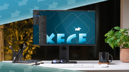 Desktop computer displaying the Xfce Linux desktop environment, set on a clean desk with a keyboard, mouse, mug, notebook, pens, sunglasses, and a potted plant.