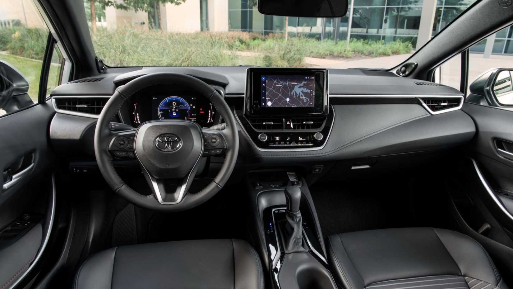 Shot inside the cabin of a 2025 Toyota Corolla showing the front seats and dashboard.