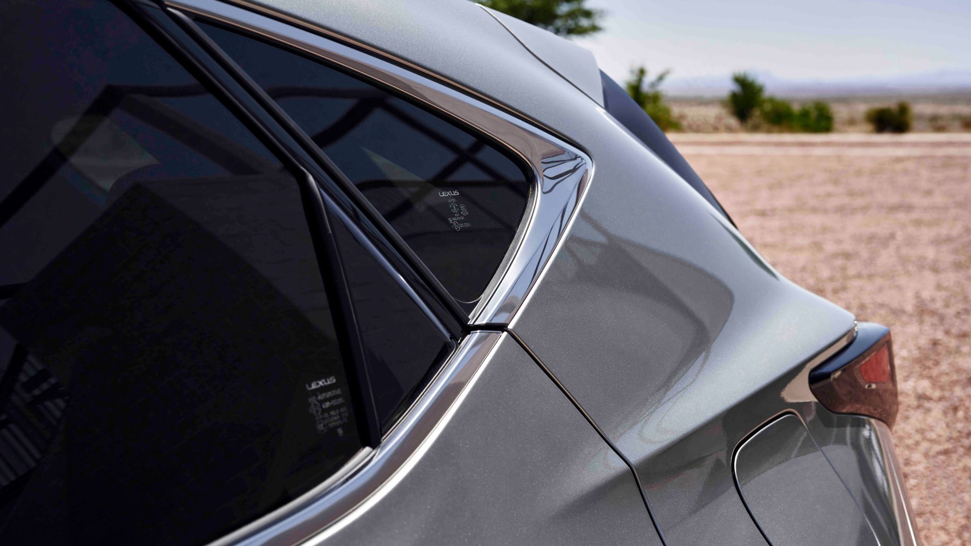 Close-up shot of the rear 3/4 of a gray 2025 Lexus NX 350h.