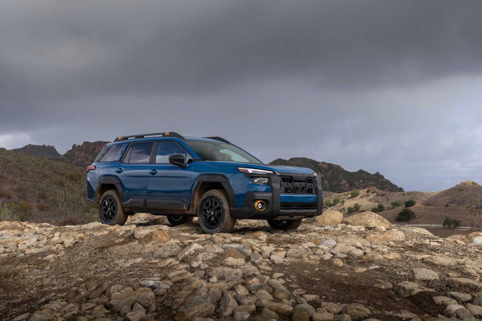 Static front 3/4 shot of a blue 2026 Subaru Outback Wilderness.
