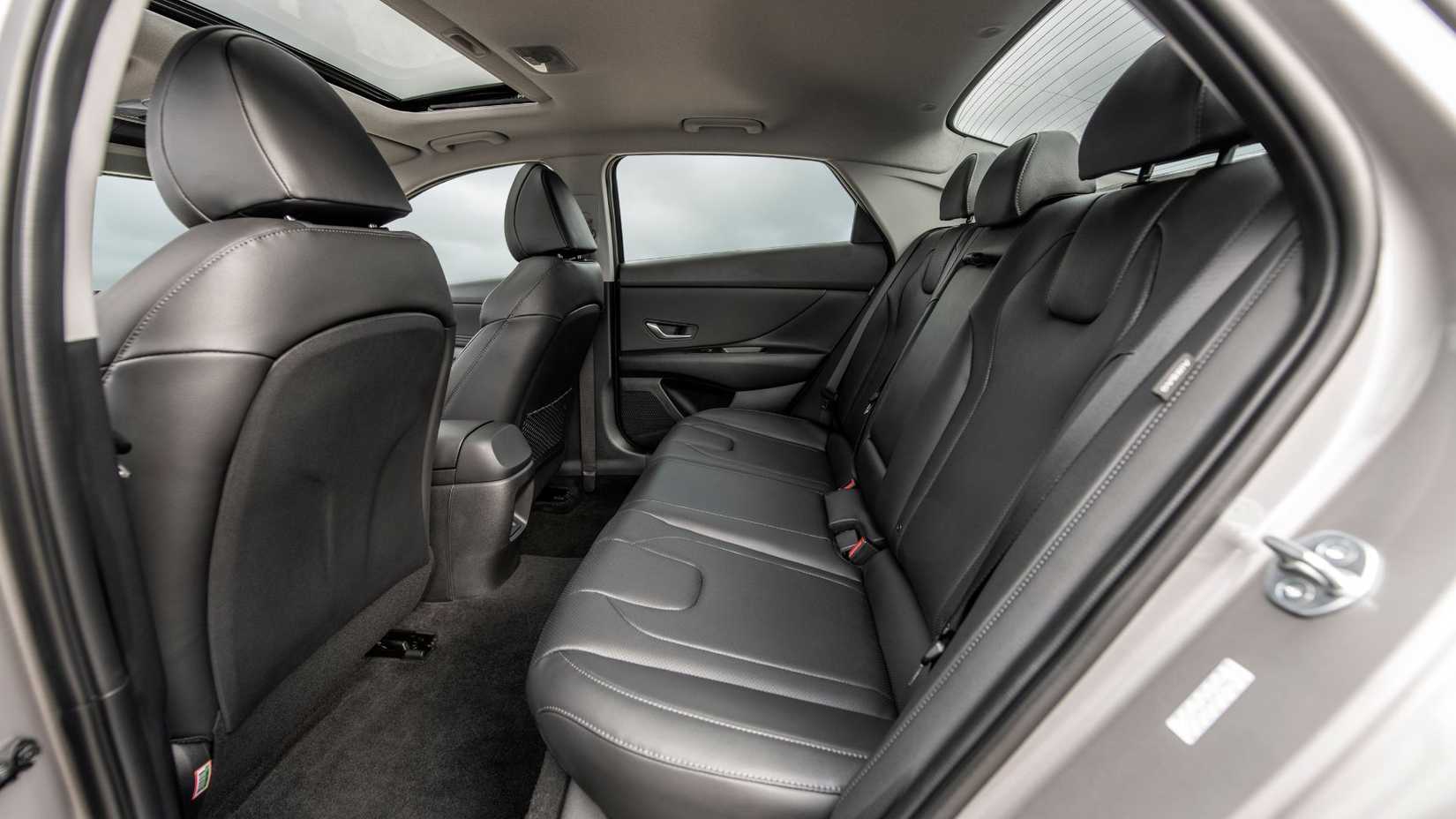 Shot inisde the cabin of a 2025 Hyundai Elantra showing the black leather rear seats.
