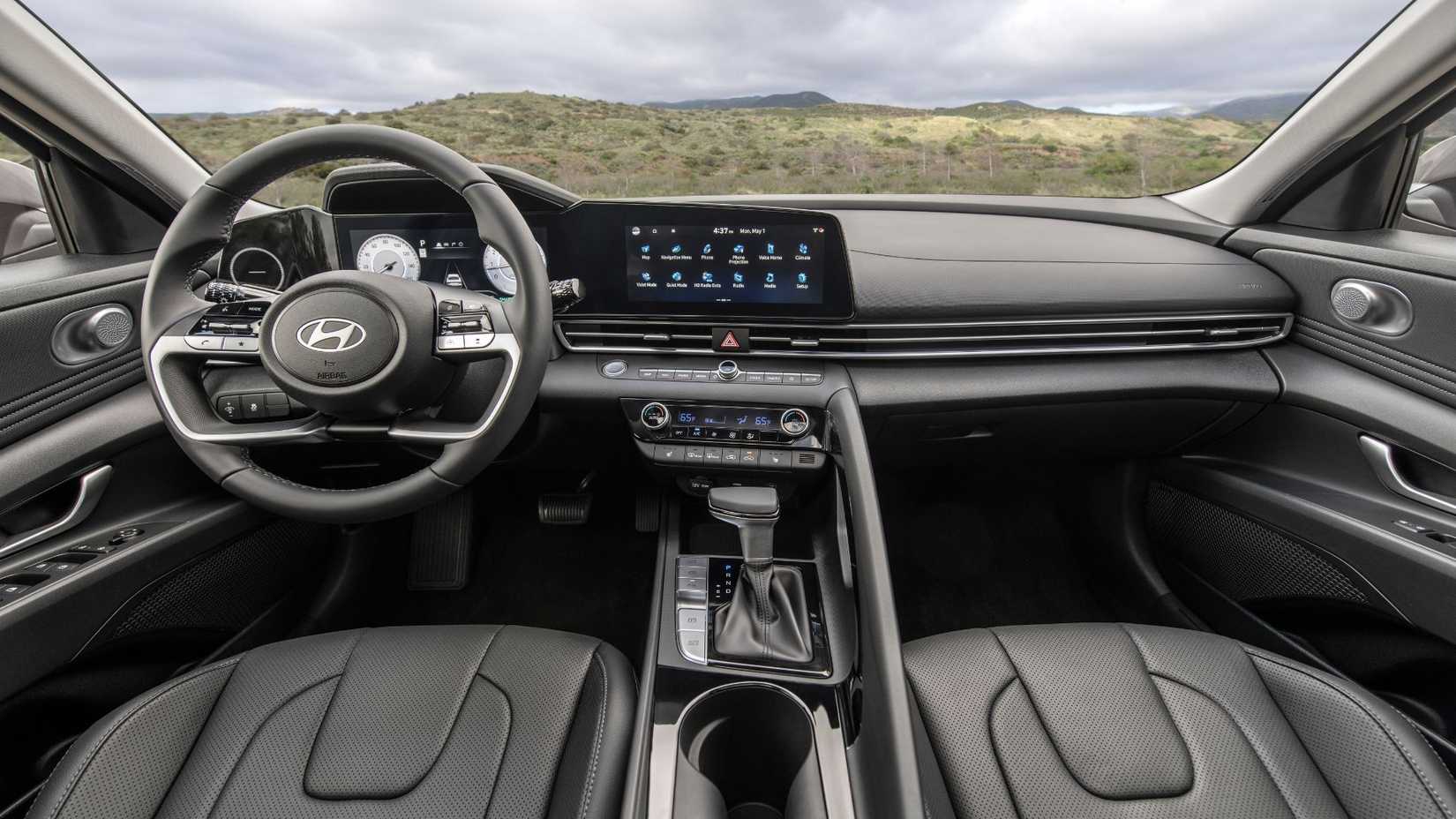 Shot inside the cabin of a 2025 Hyundai Elantra showing the black leather front seats and dashboard.