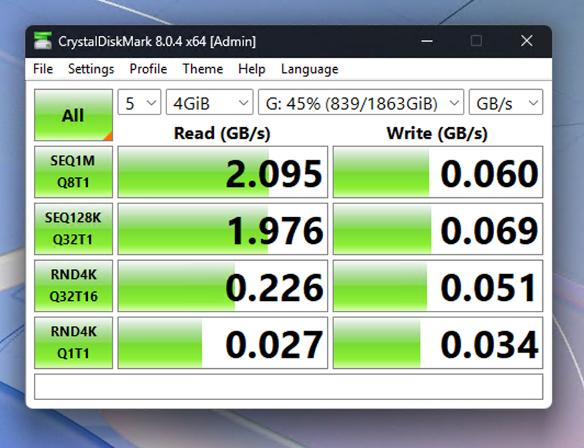 CrystalDiskMark benchmark results showing the Crucial X10 portable SSD hitting 2.095GB/s read speeds with 4GB test files.