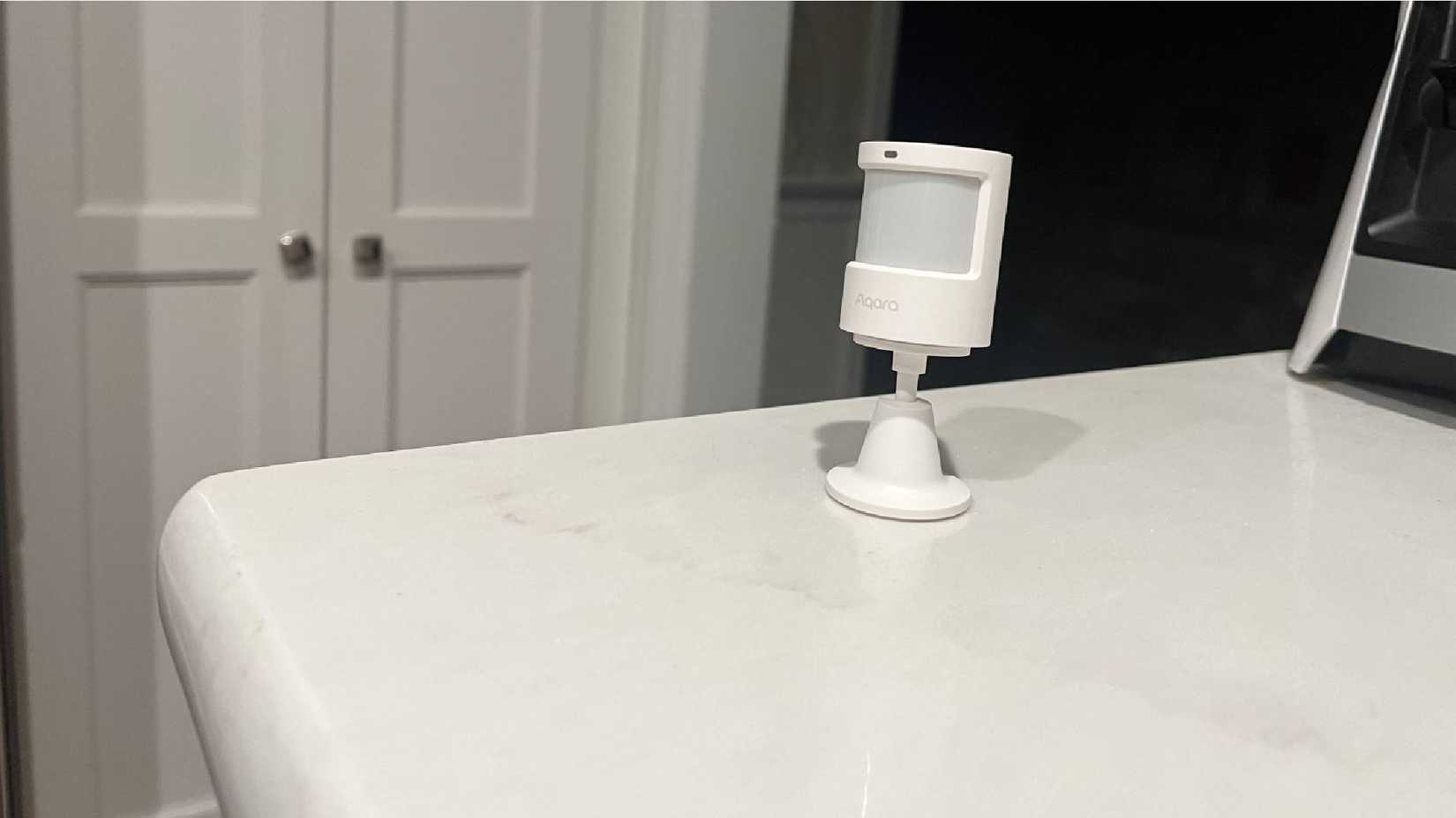 An Aqara Light and Motion Sensor P2 sitting on a countertop.