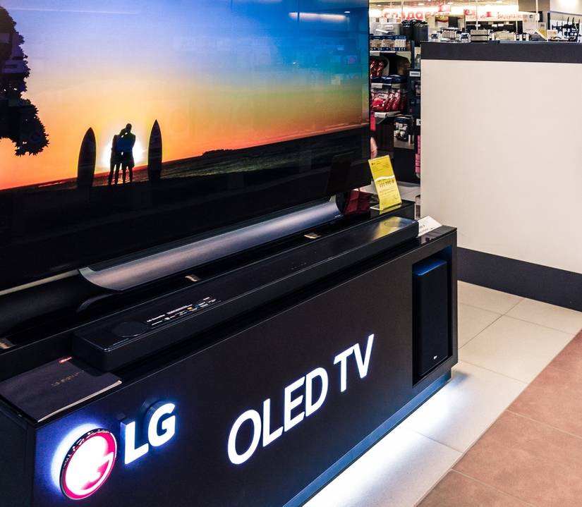 8k OLED TV LG home theater system, showing a demo picture in an electronics shop.