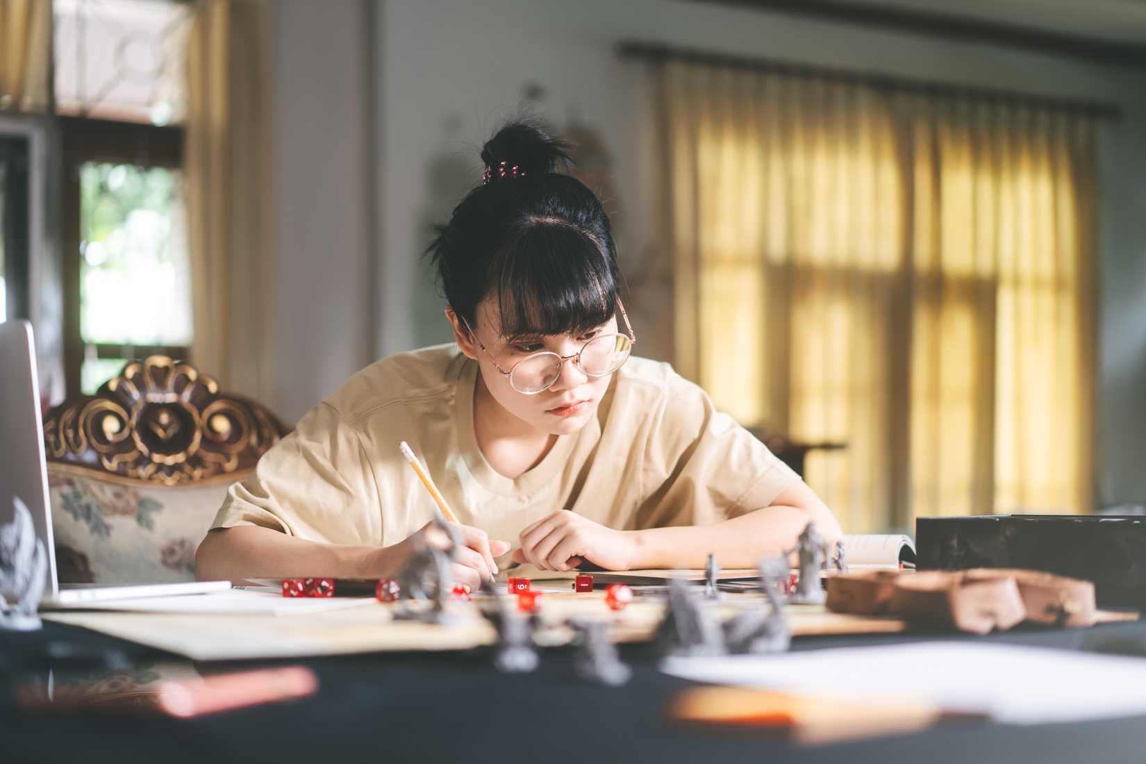 A woman of asian descent plays a tabletop RPG.