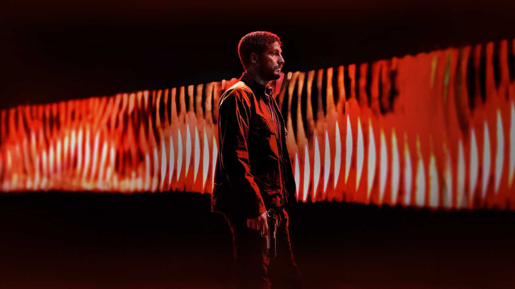 A man holding a gun in a scene from Upgrade.