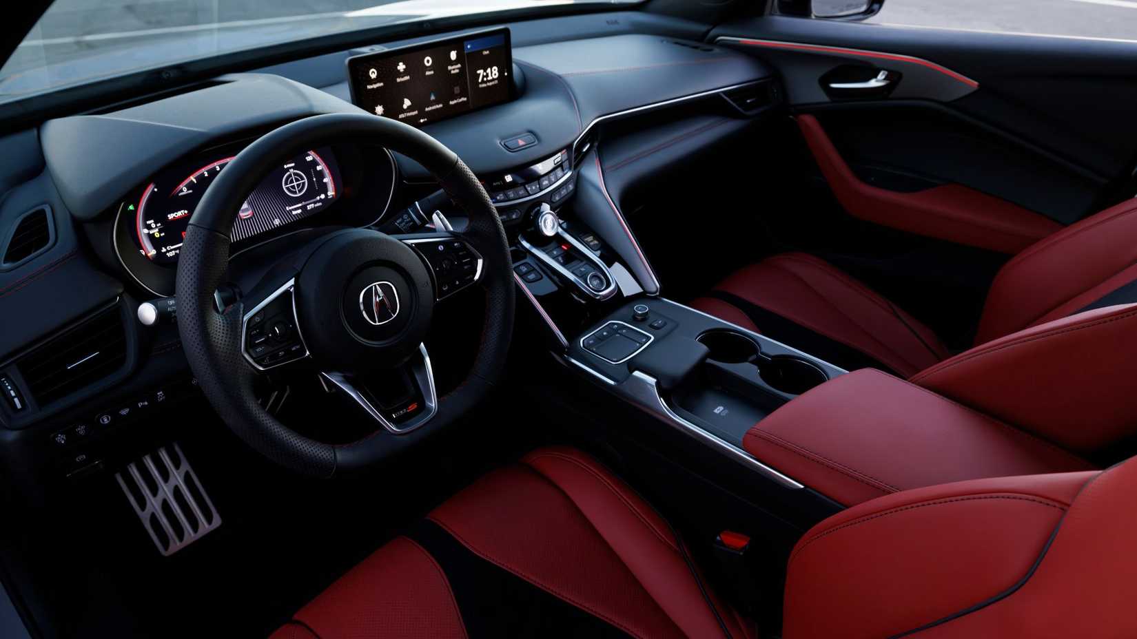 Shot inside the cabin of a 2024 Acura TLX Type S showing the red leather front seats and dashboard.