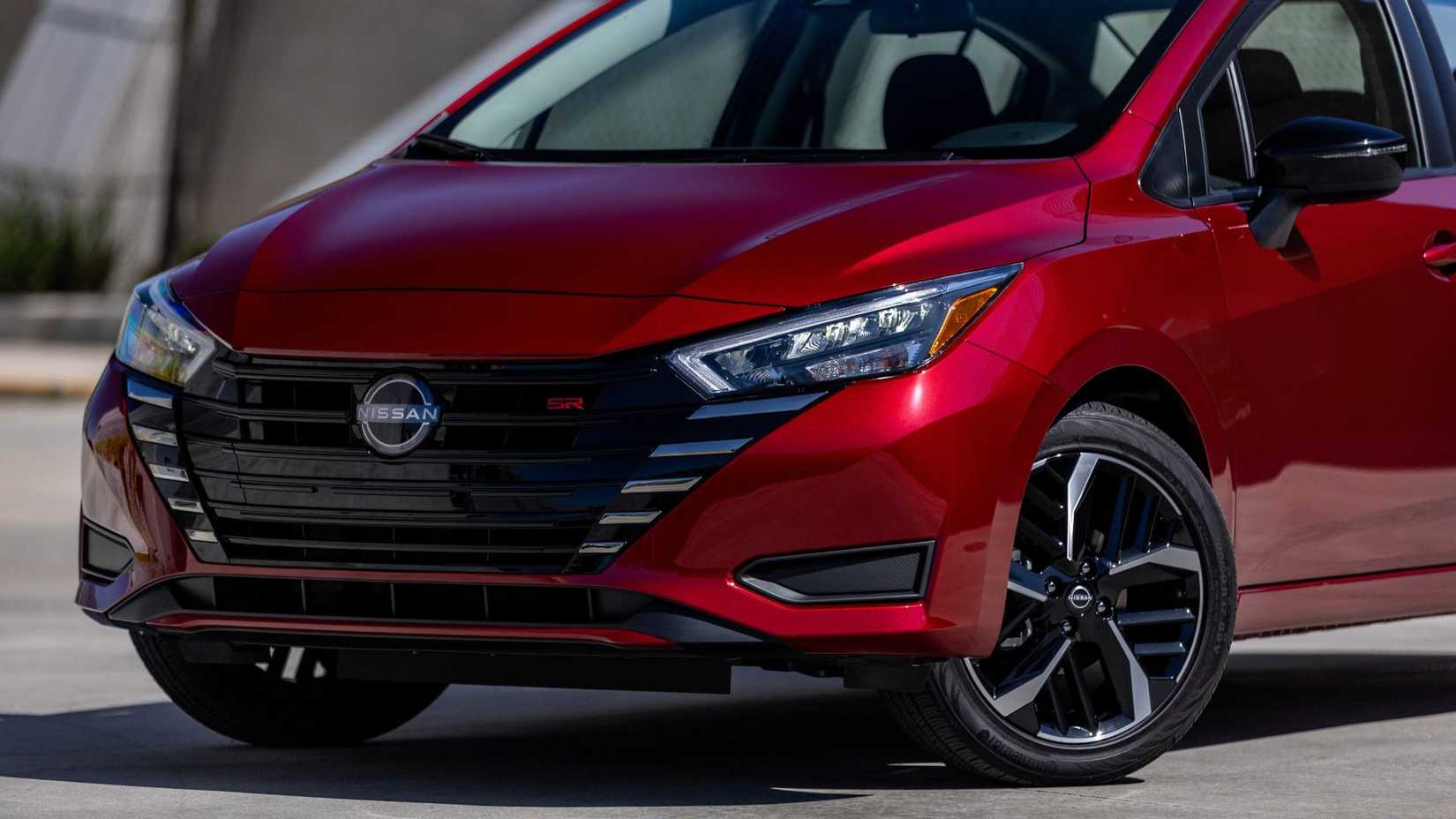 Close-up shot of the front end of a red 2025 Nissan Versa.