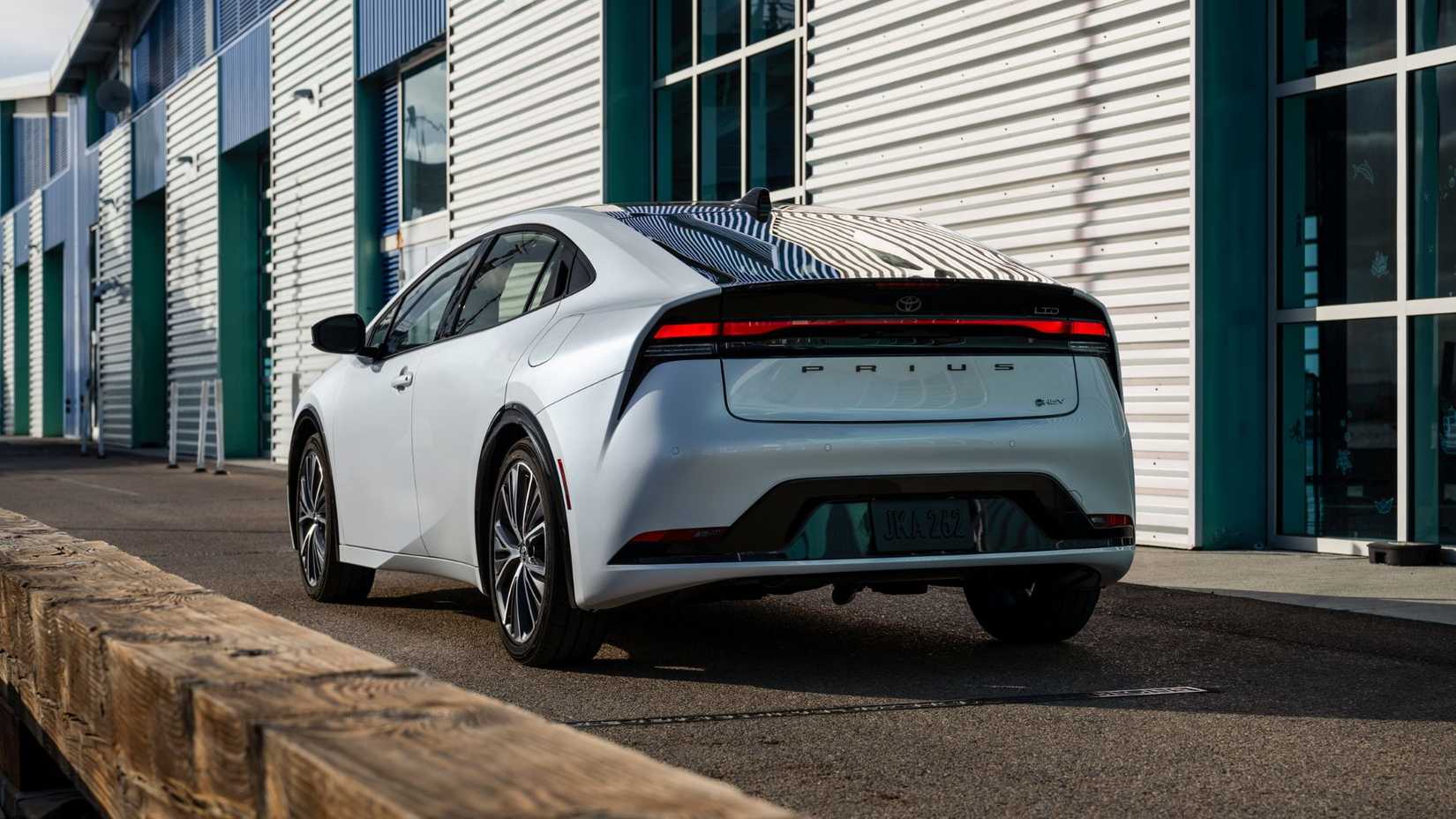 Static rear 3/4 shot of a white 2024 Toyota Prius Limited.