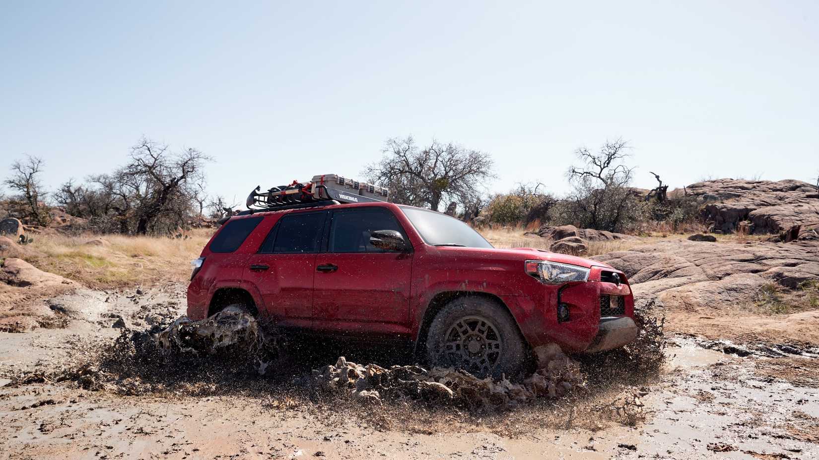 Front 3/4 shot of a 2020 Toyota 4Runner wading through mud