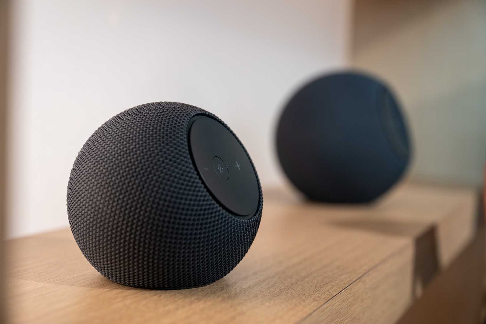 Amazon Echo Dot Max and Studio sitting on a shelf.