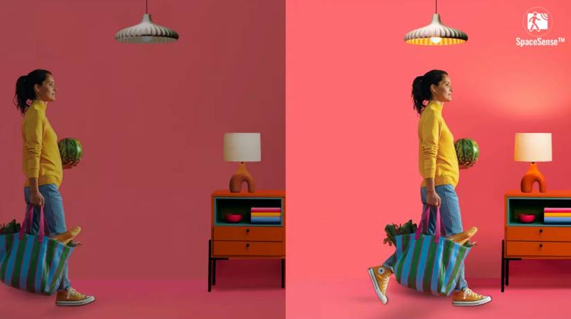 A promotional image for the WiZ SpaceSense feature showing a light triggered by a woman walking through a room.