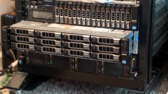 A rack-mount server slid out of the rack slightly with other servers above and below it.