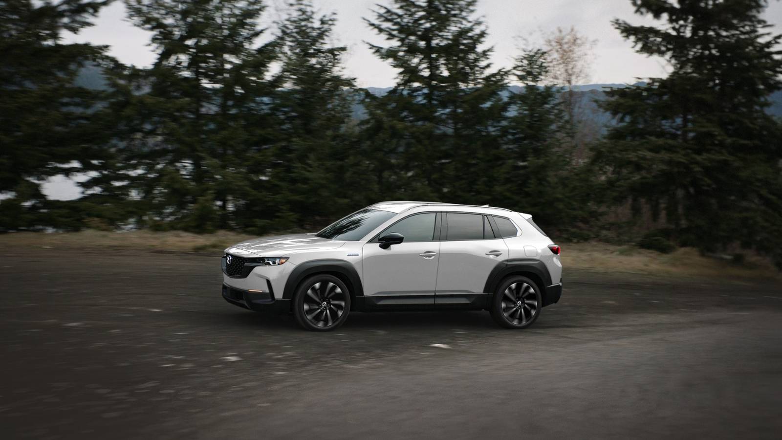 Front 3/4 action shot of a 2025 Mazda CX-50 Hybrid