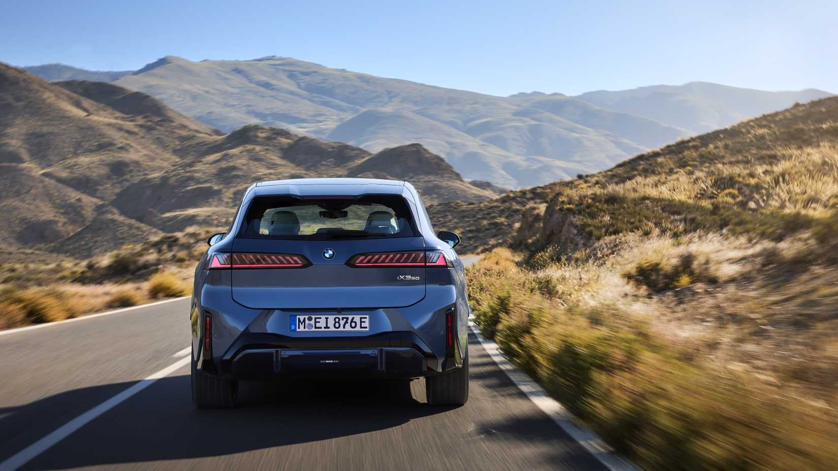 Rear action shot of a 2026 BMW iX3