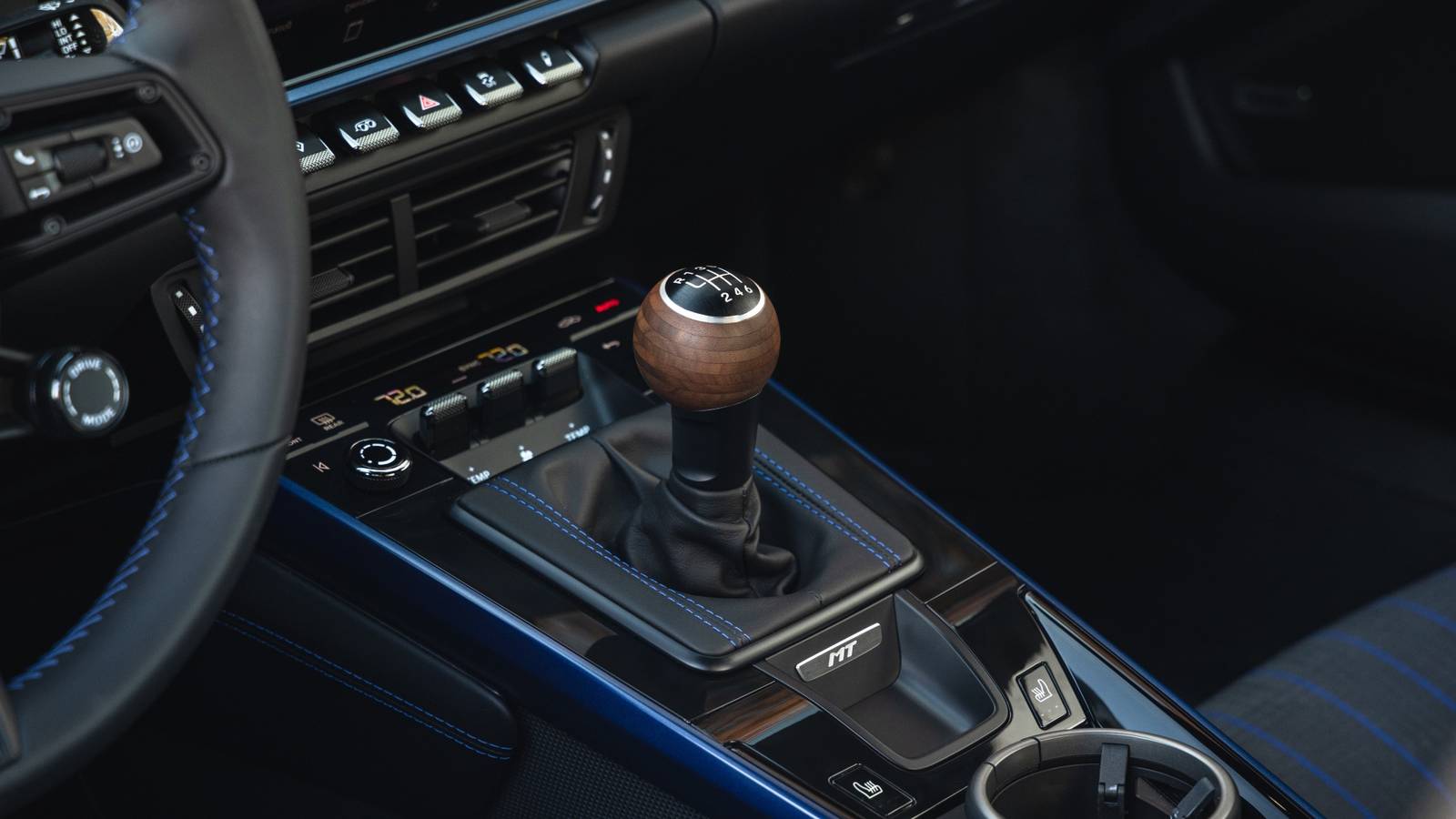 Close-up of a hatchback interior emphasizing the manual driving experience with a focused view of the gear area
