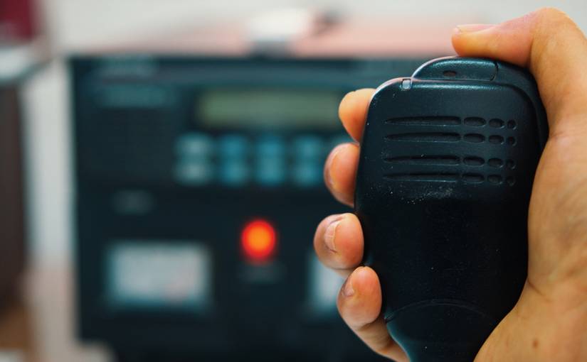A person holding a radio microphone.