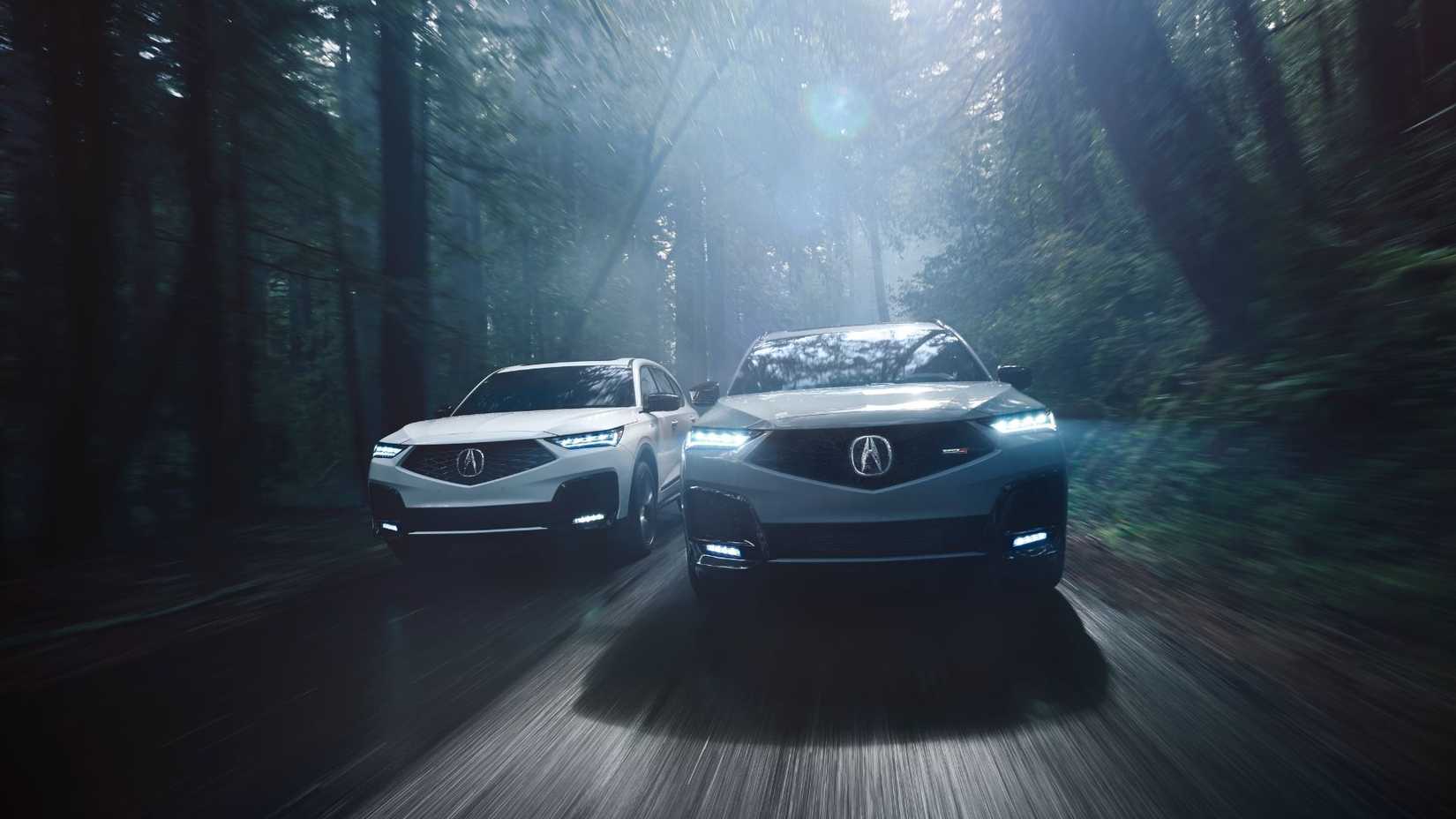 Dynamic front-end shot of a 2025 Acura MDX A-Spec and MDX Type S driving side by side.