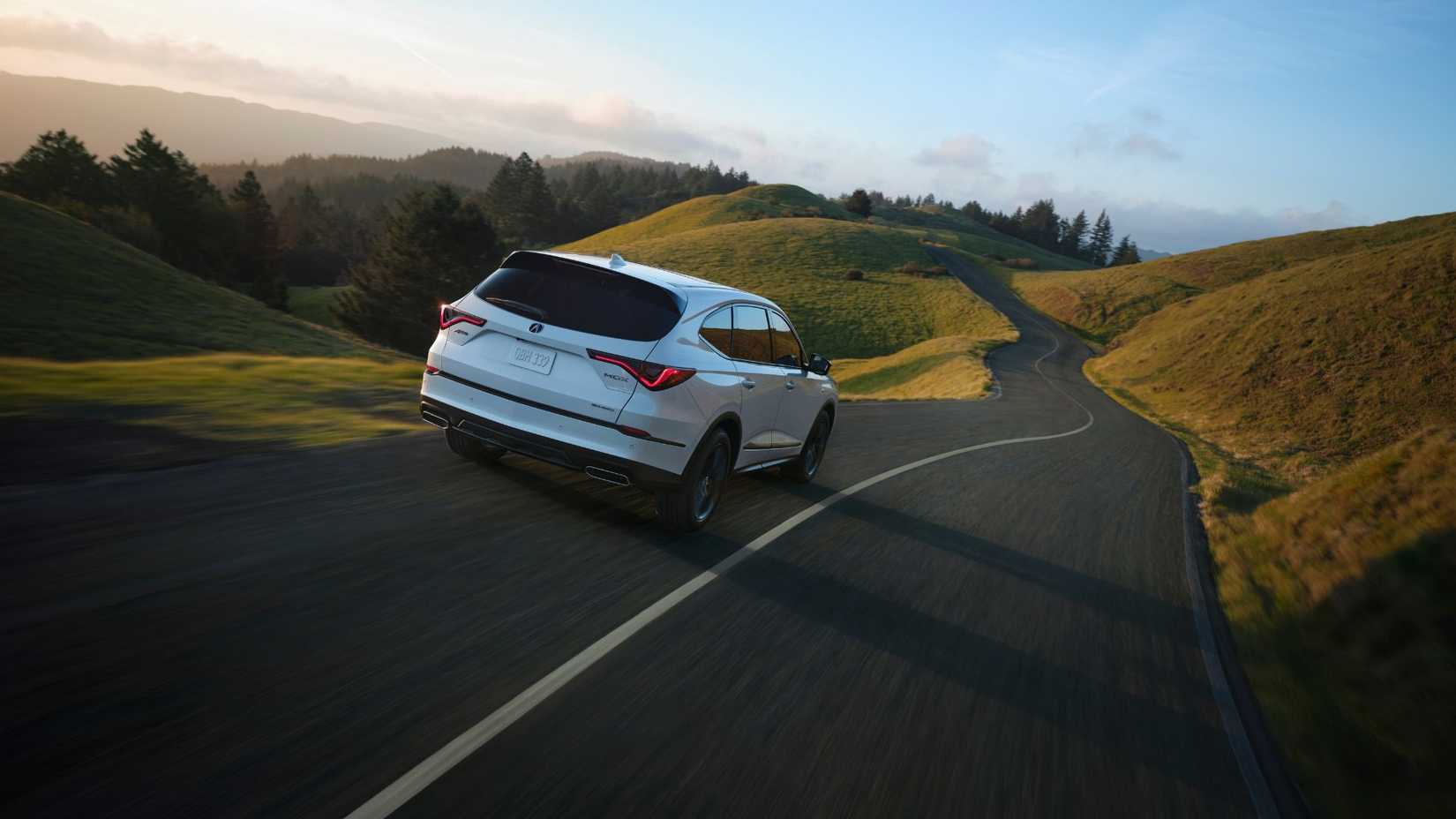Dynamic rear 3/4 shot of a white 2025 Acura MDX A-Spec.