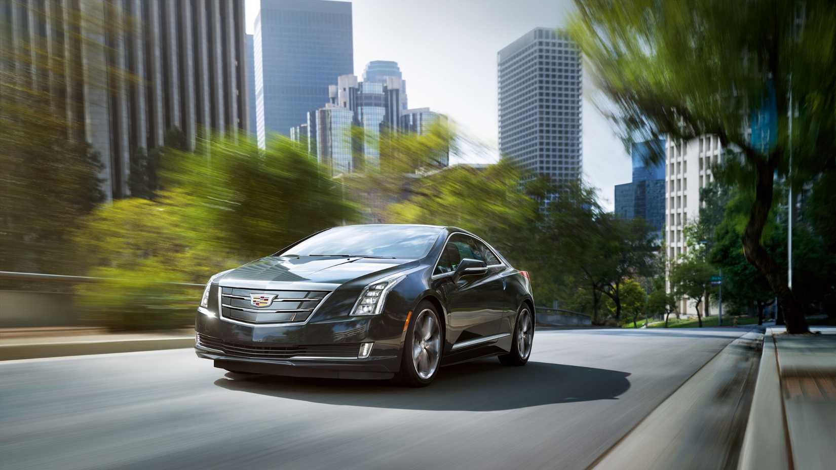 Dynamic front 3/4 shot of a 2016 Cadillac ELR driving in the city.