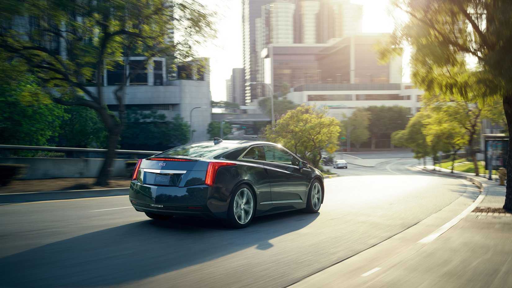 Dynamic 3/4 rear shot of a 2016 Cadillac ELR driving in the city.