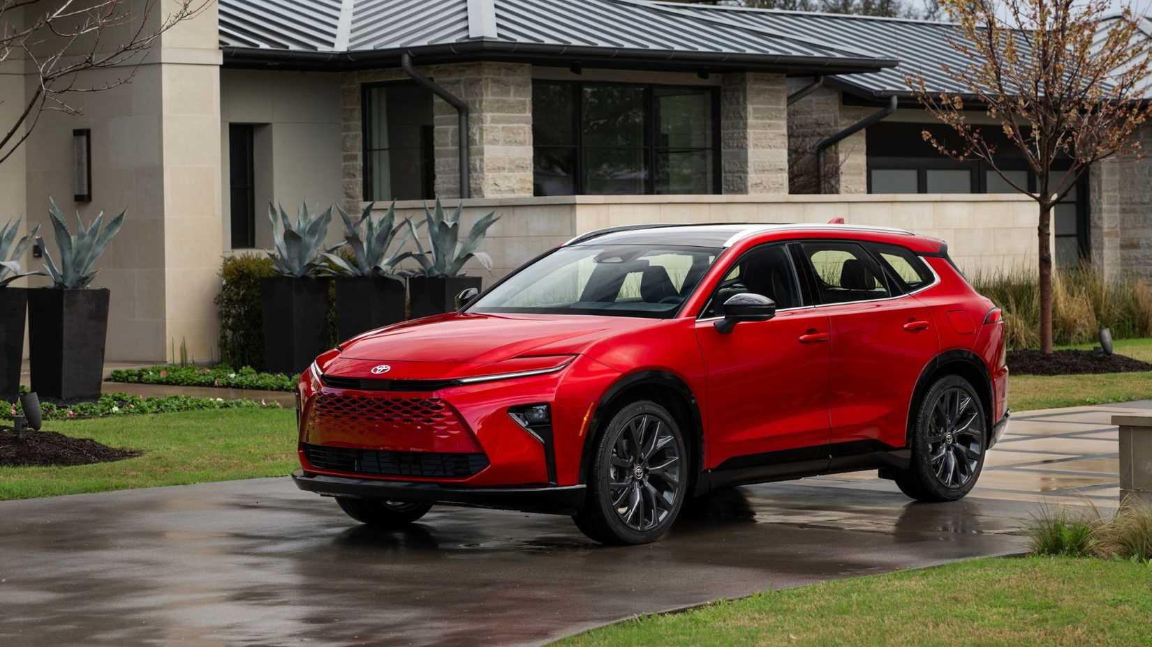 Static front 3/4 shot of a red 2025 Toyota Crown Signia Limited.