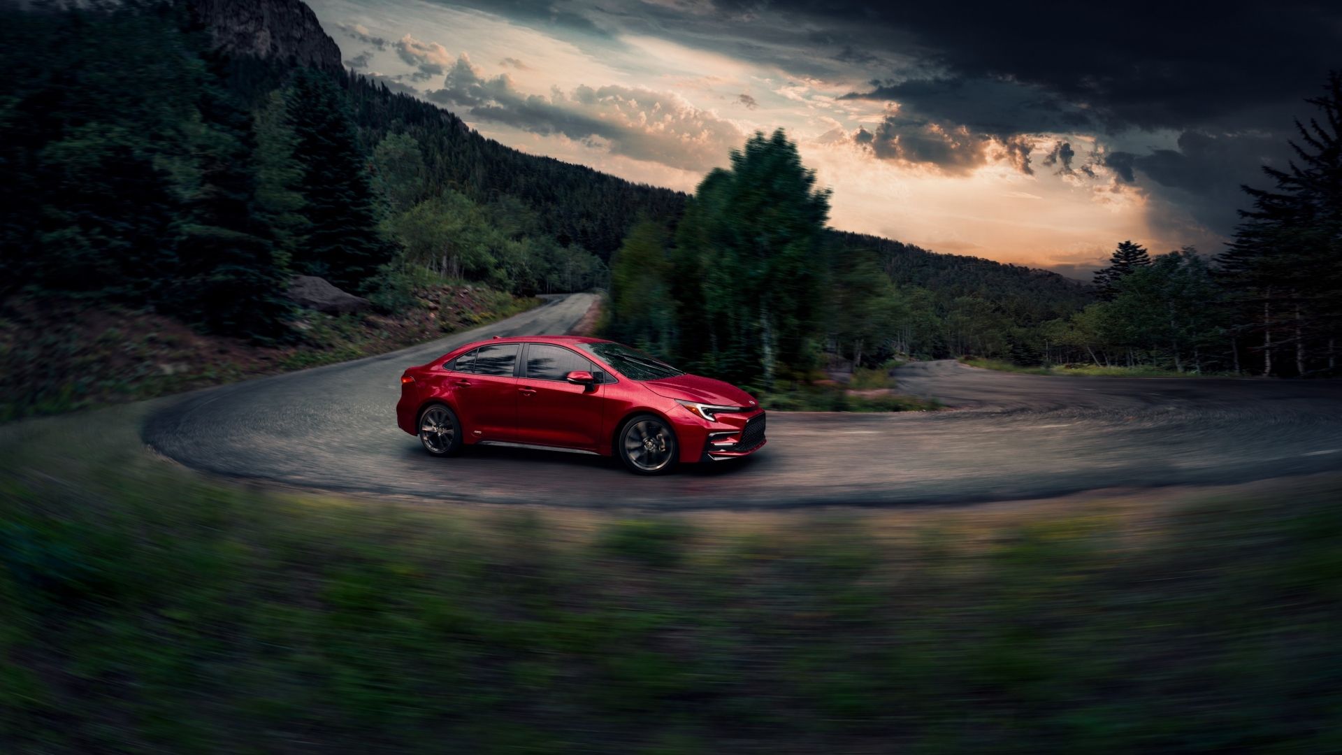 Front 3/4 action shot of a 2026 Toyota Corolla Hybrid