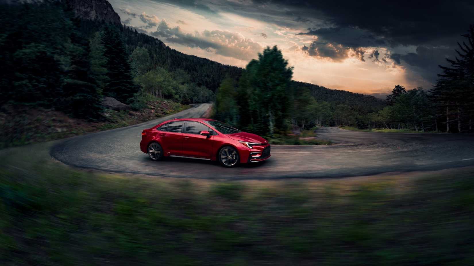 Front 3/4 action shot of a 2026 Toyota Corolla Hybrid