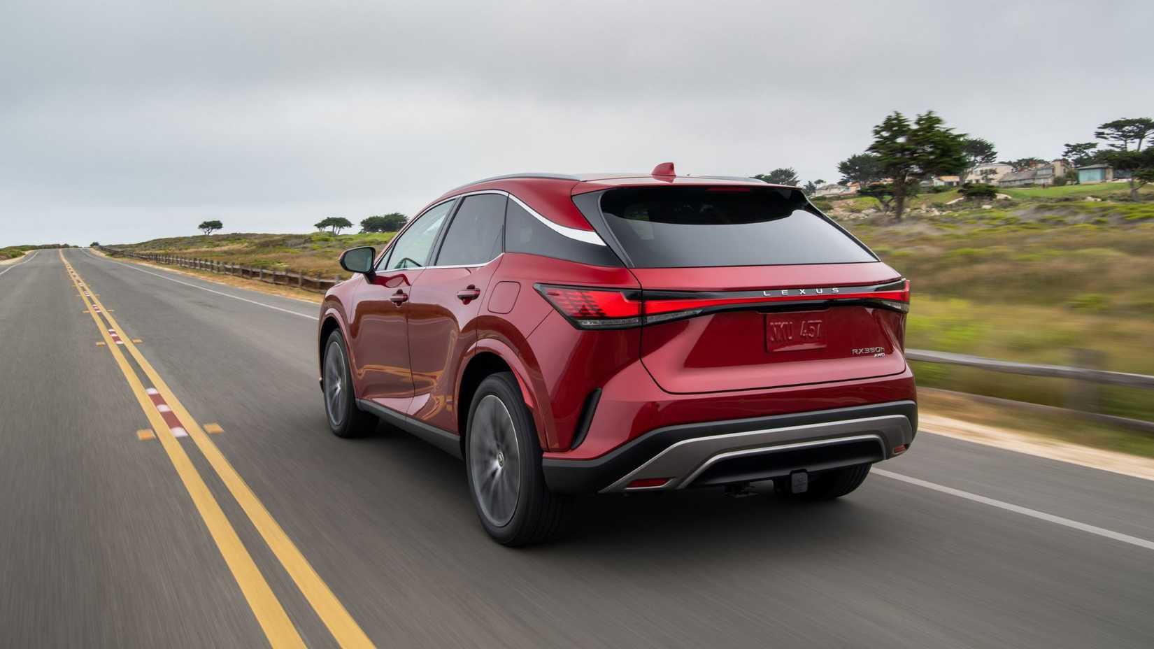 Dynamic rear 3/4 shot of a red 2026 Lexus RX 350h.