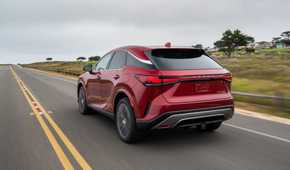 Dynamic rear 3/4 shot of a red 2026 Lexus RX 350h.