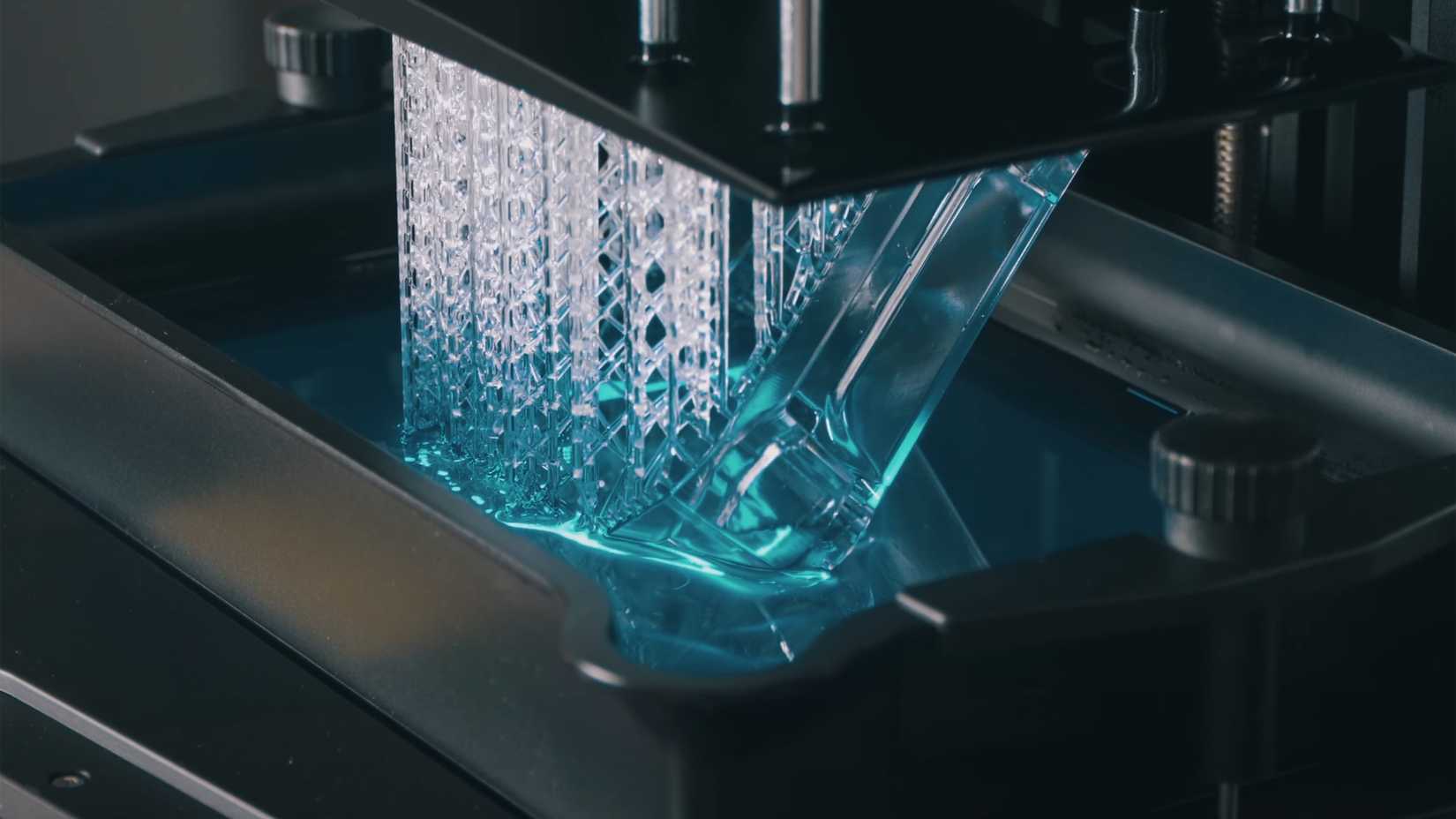 A 3D print growing out of a resin printer.