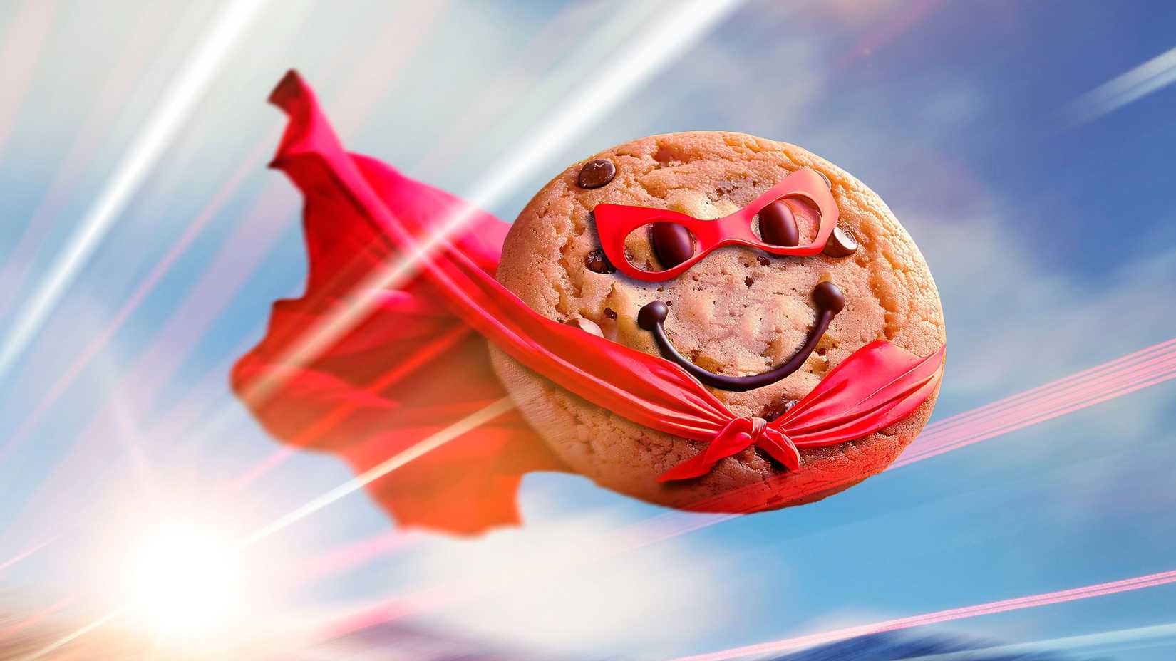 Um biscoito com capa e máscara de super-herói, voando.