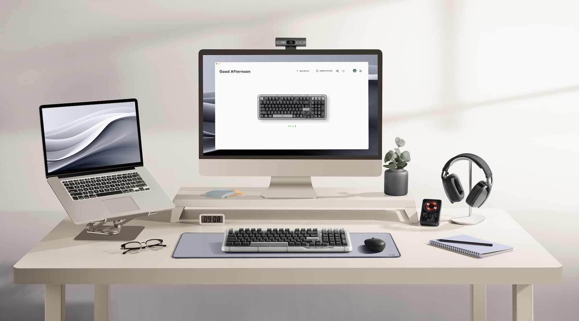 A desktop set up with a laptop and headphones with an Alto Keys K98M in the middle