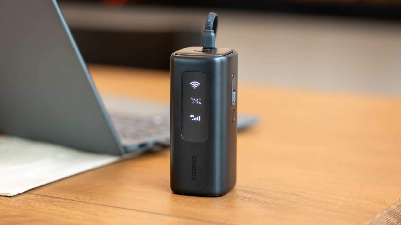 baseus energeek gx11 4G mifi power bank on desk beside an open laptop