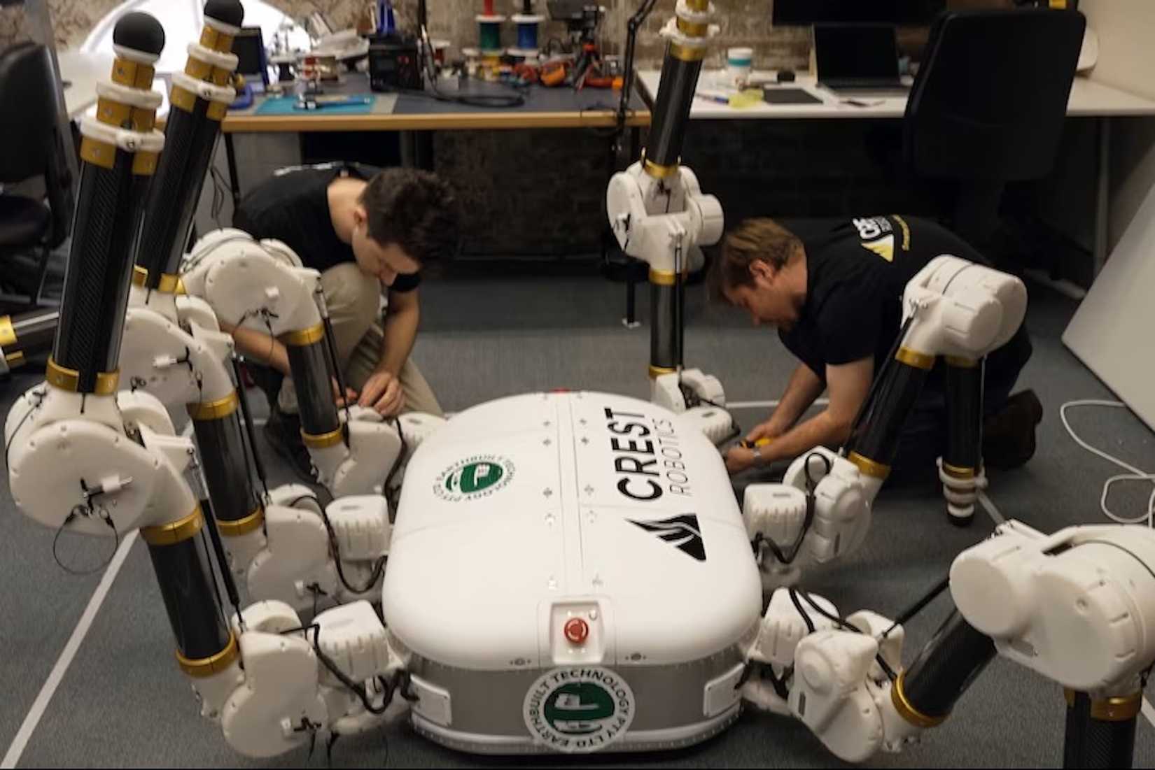 Charlotte the robot being worked on by a team of technicians.