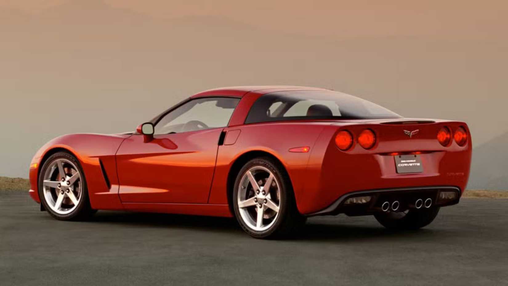 Still 3/4 rear shot of a red Chevrolet Corvette C6.