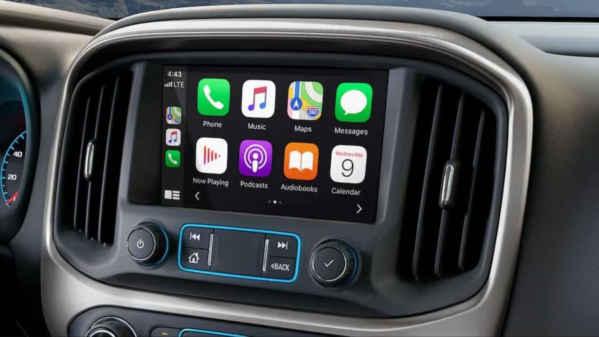 Close-up shot of the infotainment screen displaying Apple CarPlay in a GMC.