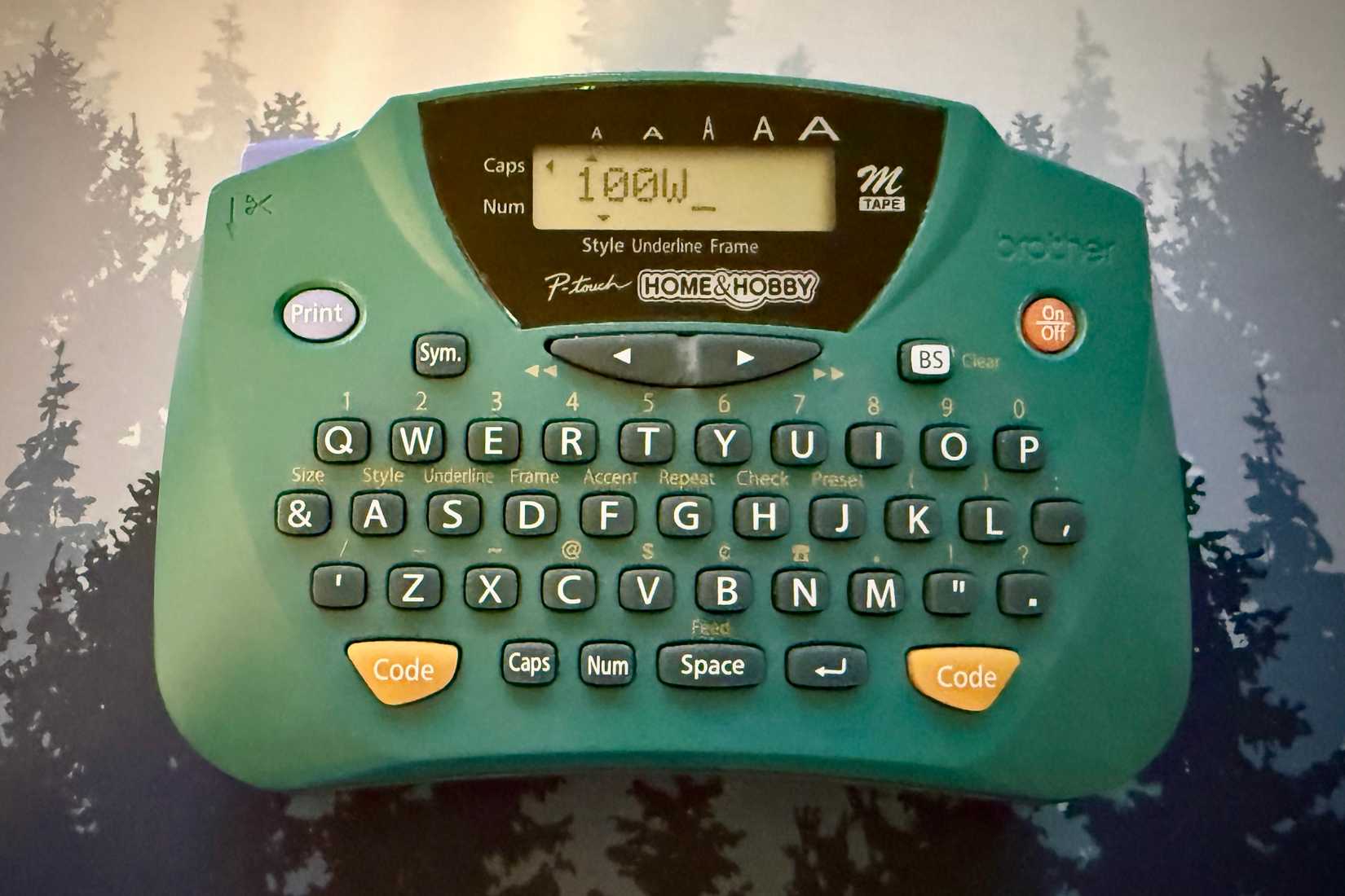 Label maker making a label saying "100W."