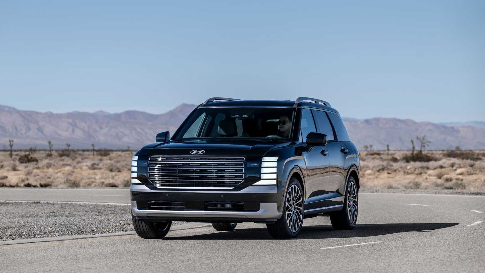 Dynamic front 3/4 shot of a 2026 Hyundai Palisade Hybrid Calligraphy.