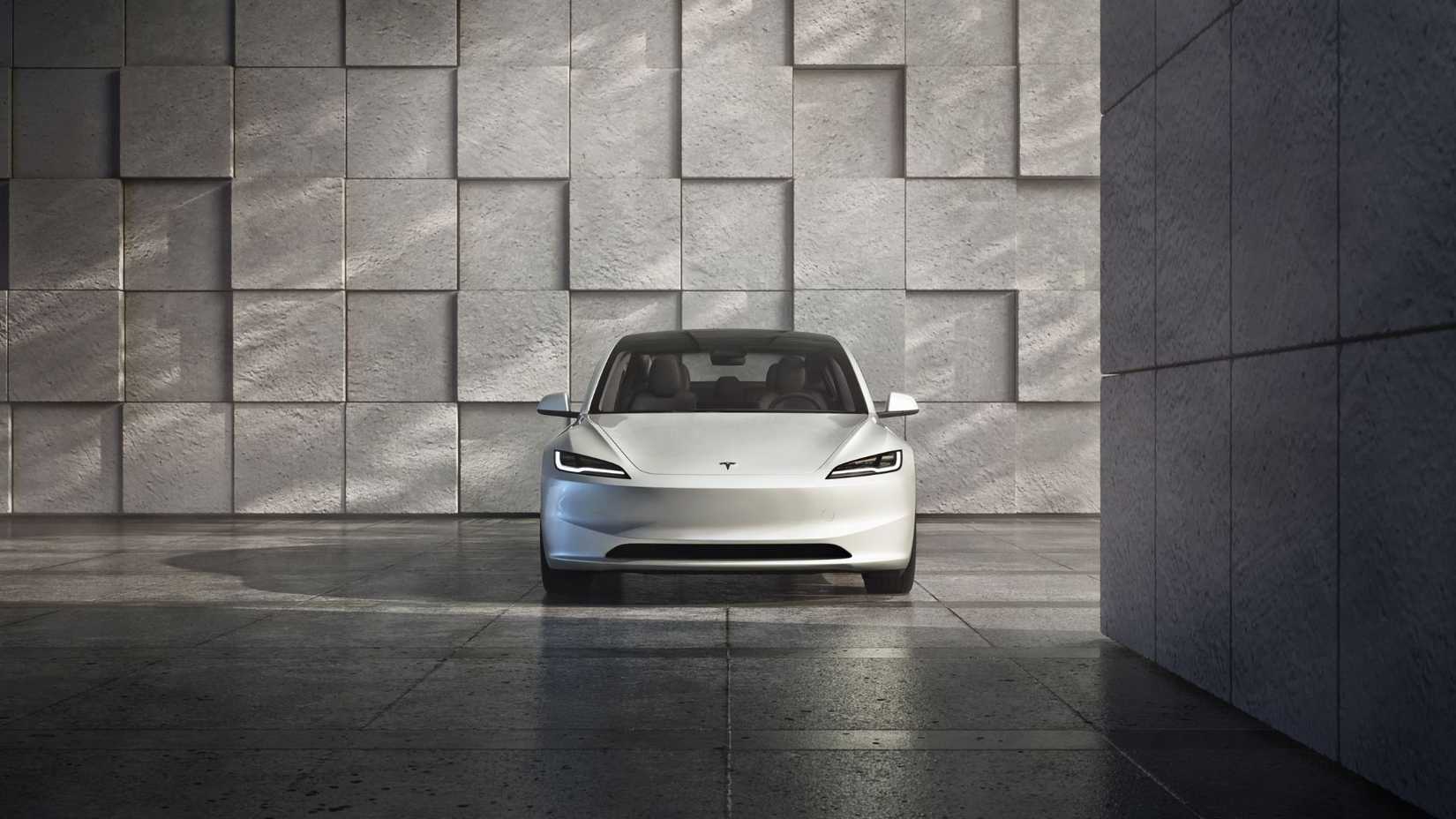 Statci front-end shot of a white Tesla Model 3 Performance.
