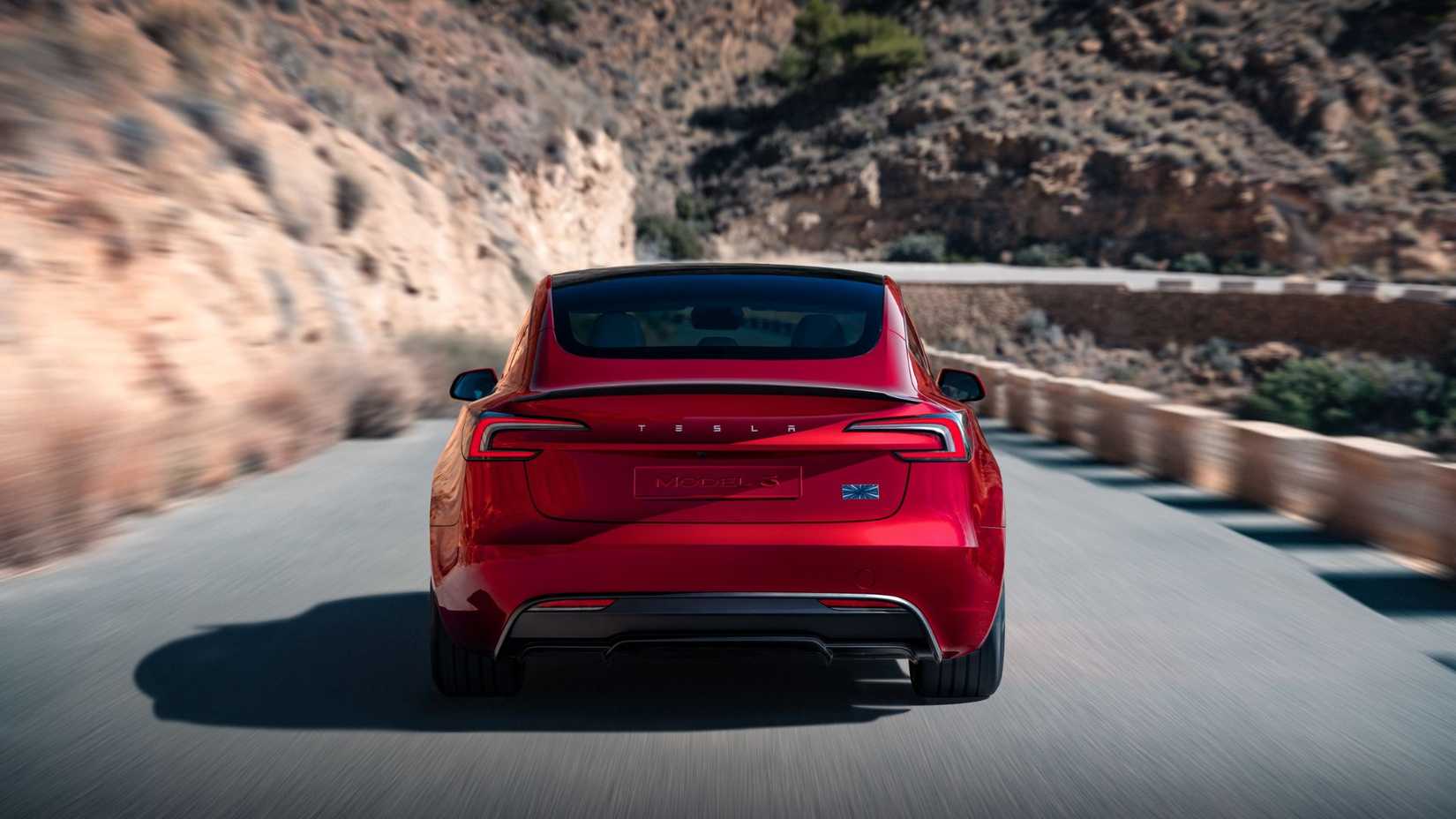 Красная Tesla Model 3 Performance сзади в движении