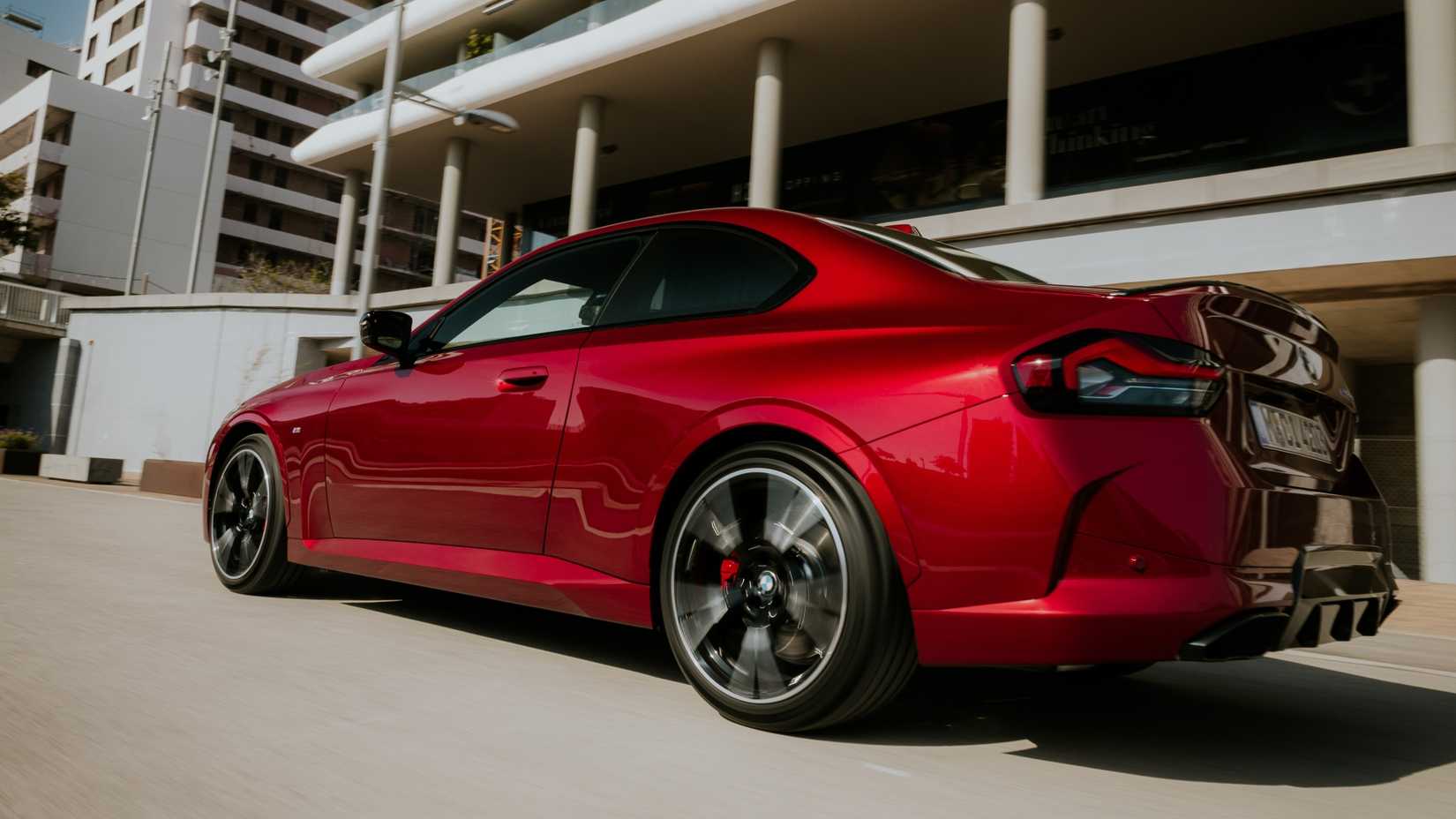 Rear 3/4 action shot of a 2025 BMW M240i