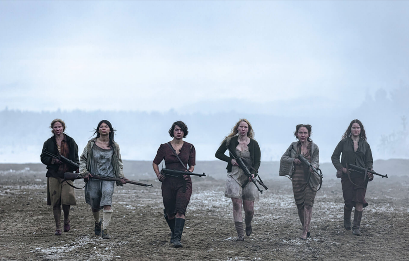 Image of six Finnish women carrying weapons across barren terrain from Sisu.