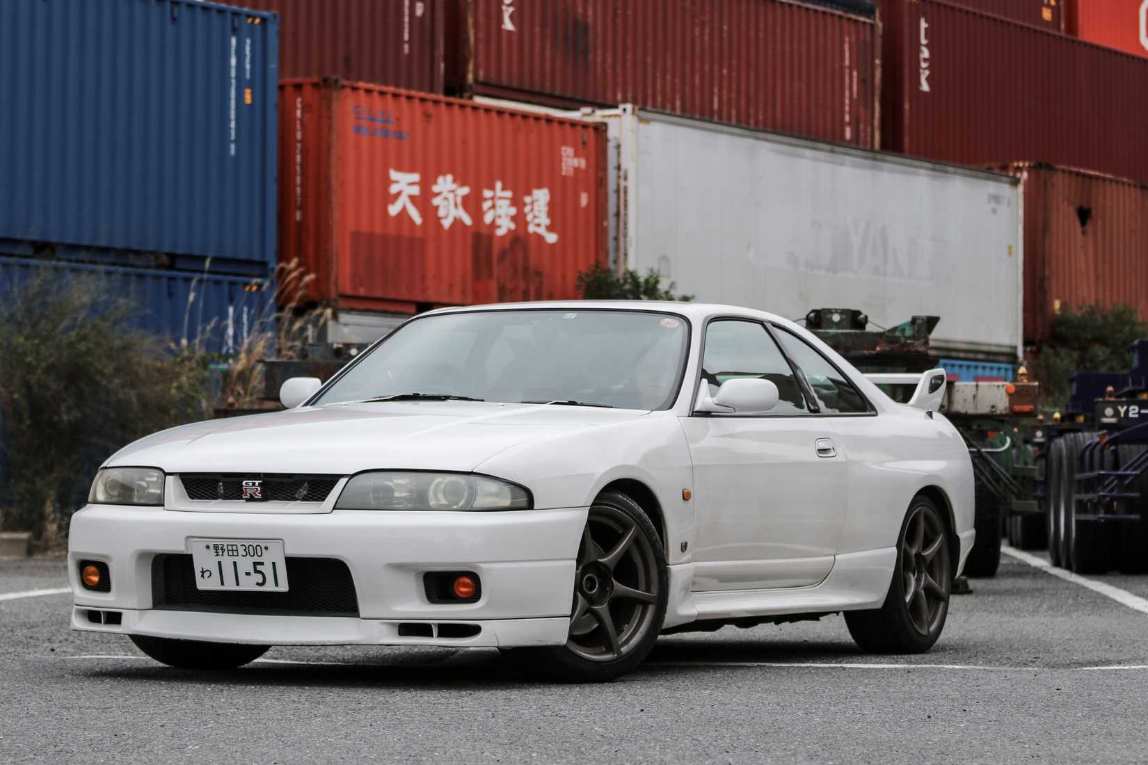 Yokohama, Japan - November 08, 2018: Nissan skyline GTR33 (BNR33) cruises through the Yokohama industrial harbor.