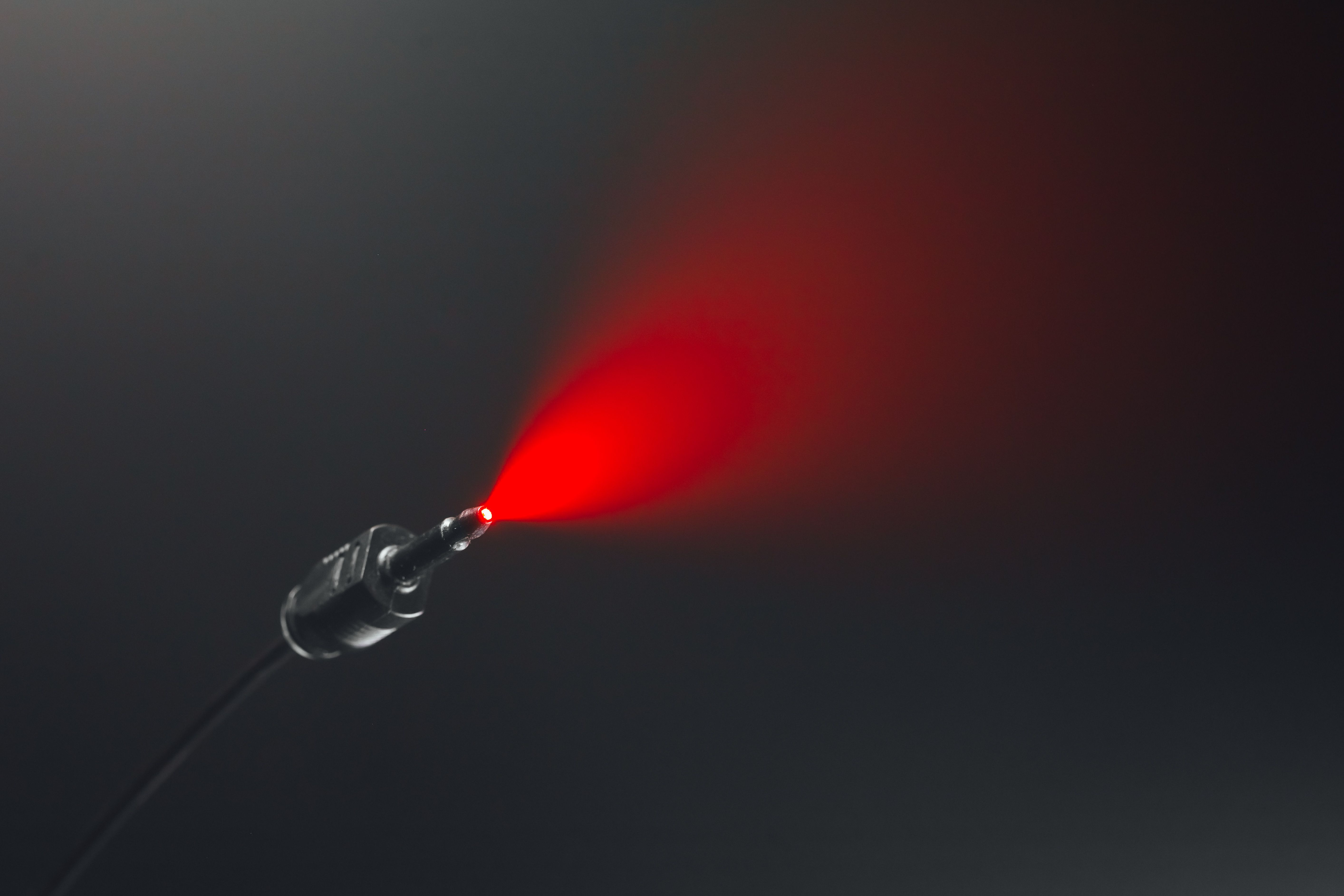 A TOSLINK cable shines red light.
